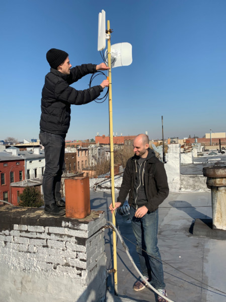 Figure 10: Photograph of a rooftop bearing both an omni-directional and a directional router antenna.