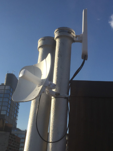Figure 11: Photograph of a rooftop bearing both an omni-directional and a directional router antenna.