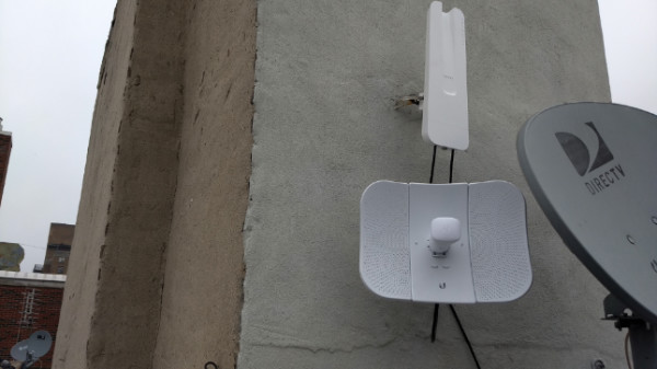 Figure 12: Photograph of a rooftop bearing both an omni-directional and a directional router antenna.