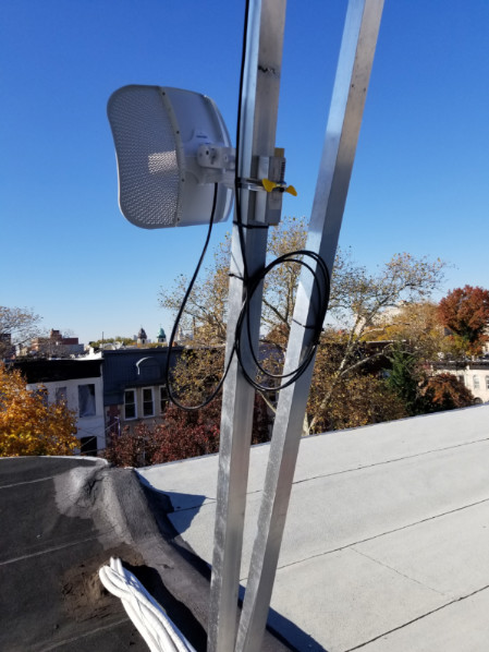 Figure 5: Ubiquiti LiteBeam AC mounted on existing roof infrastructure.