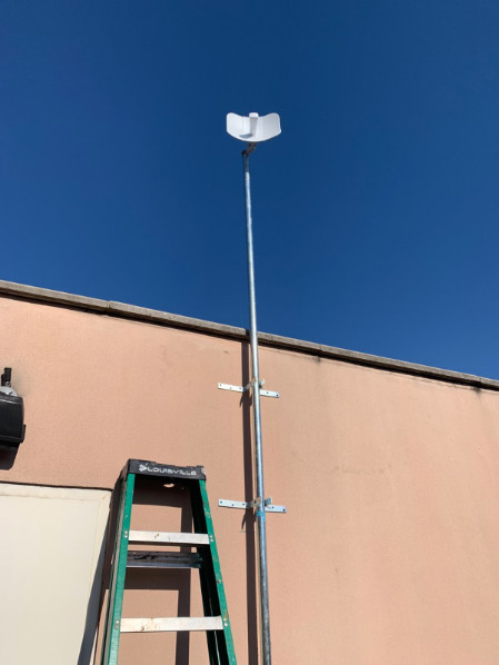 Figure 6: Ubiquiti LiteBeam AC mounted on a tall roof pole.